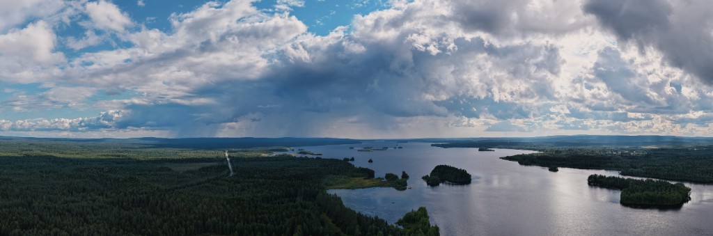 Panoramic view over water and forested islands.